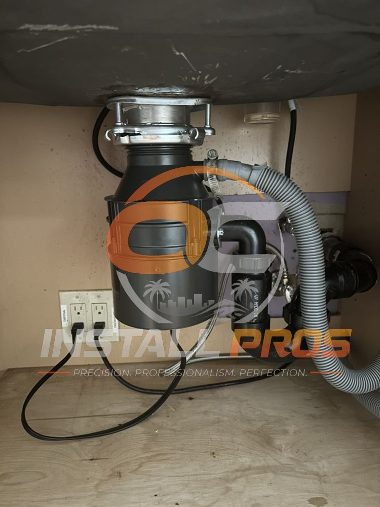 Garbage disposal unit installed and plumbed in under a kitchen sink